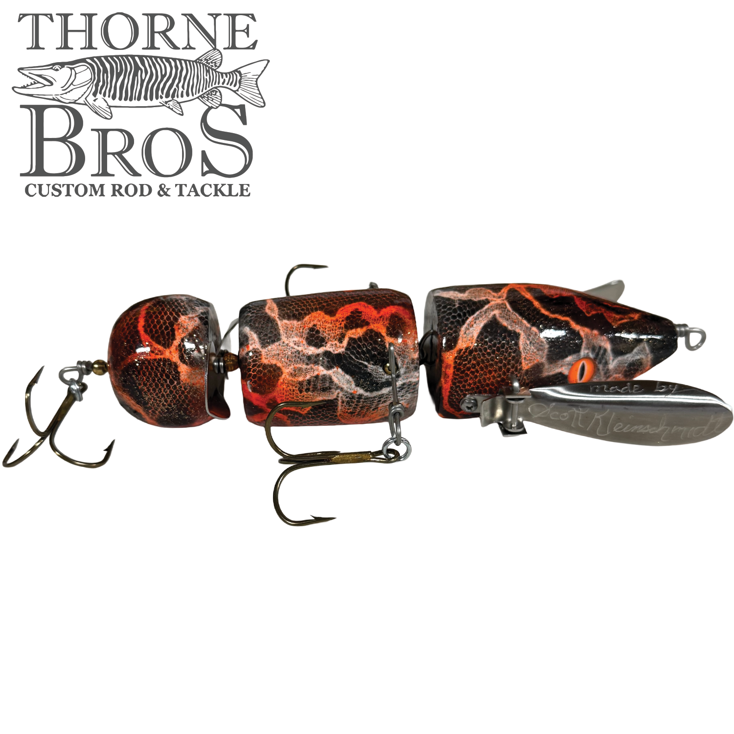 Musky Safari Franken Spitz fishing lure with segmented body featuring a red, black, and orange cracked pattern, equipped with multiple sharp treble hooks for musky fishing.
