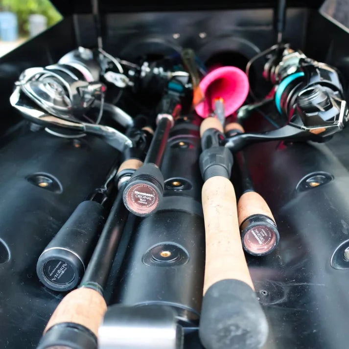 Trxstle ARC Fishing Rod Carrier holding multiple fishing rods and spinning reels with cork handles and a bright pink fishing lure
