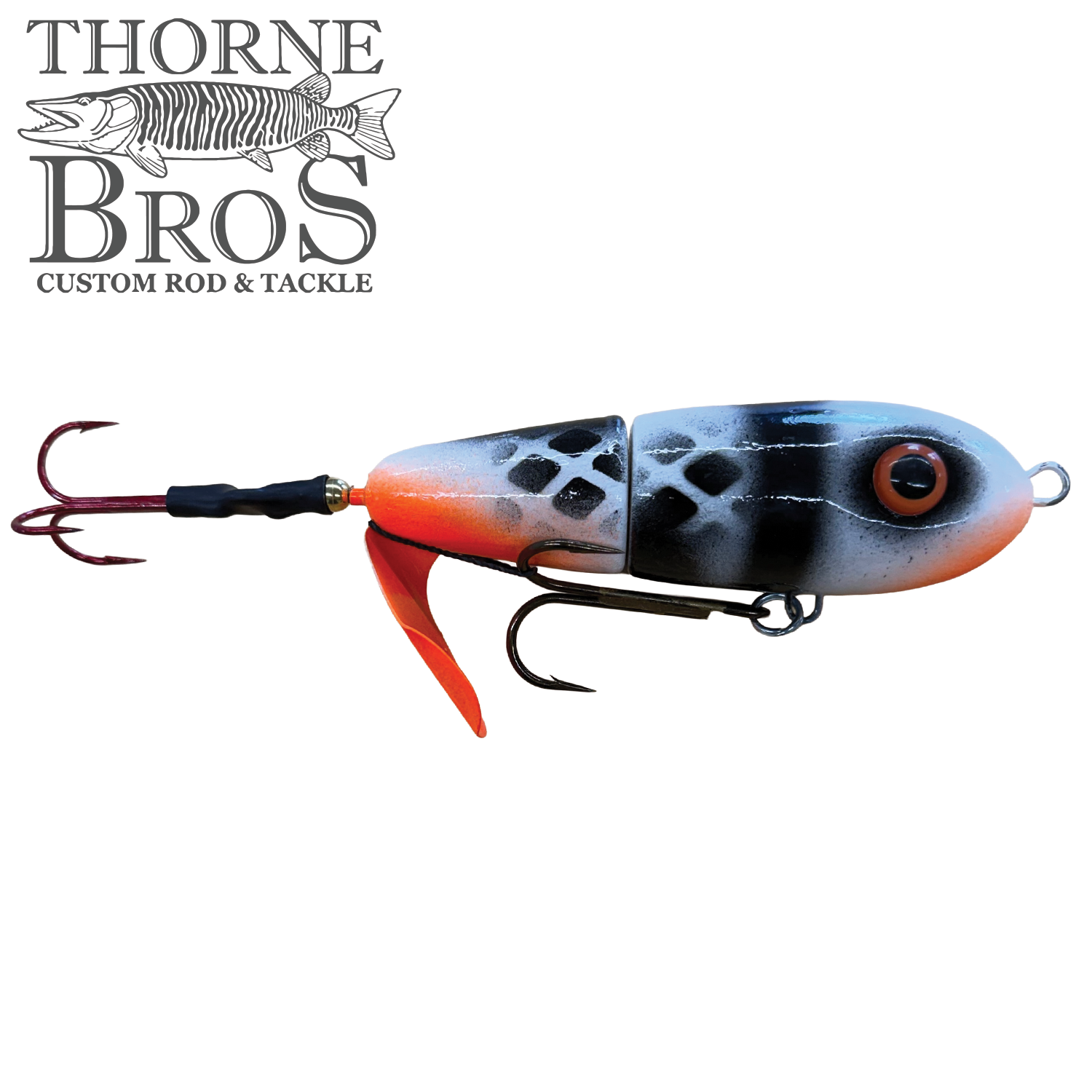 Fishing lure with segmented body painted in black, white, and orange with realistic eye detail and two treble hooks, labeled as Lake-X Dr. Evil for musky fishing.