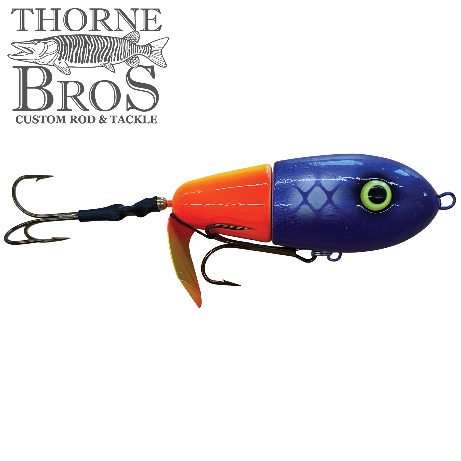 Lake-X Fat Bastard fishing lure with a segmented bright orange and purple body, detailed fish eye, and two sharp treble hooks designed for musky fishing.