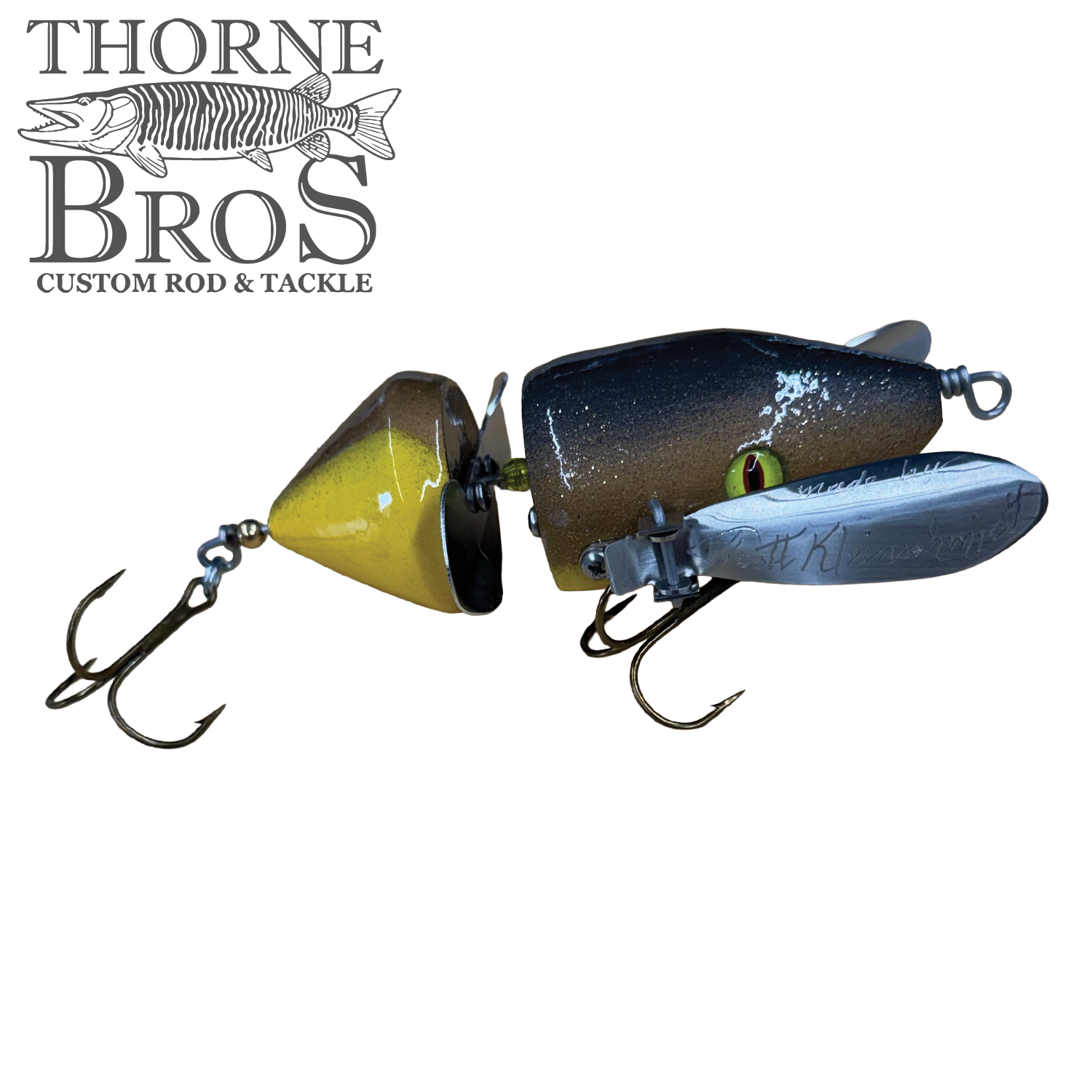 Musky Safari Mini Baby Spitzer fishing lure in brown, black, and yellow with two treble hooks, designed for musky fishing tackle and outdoor fishing enthusiasts.