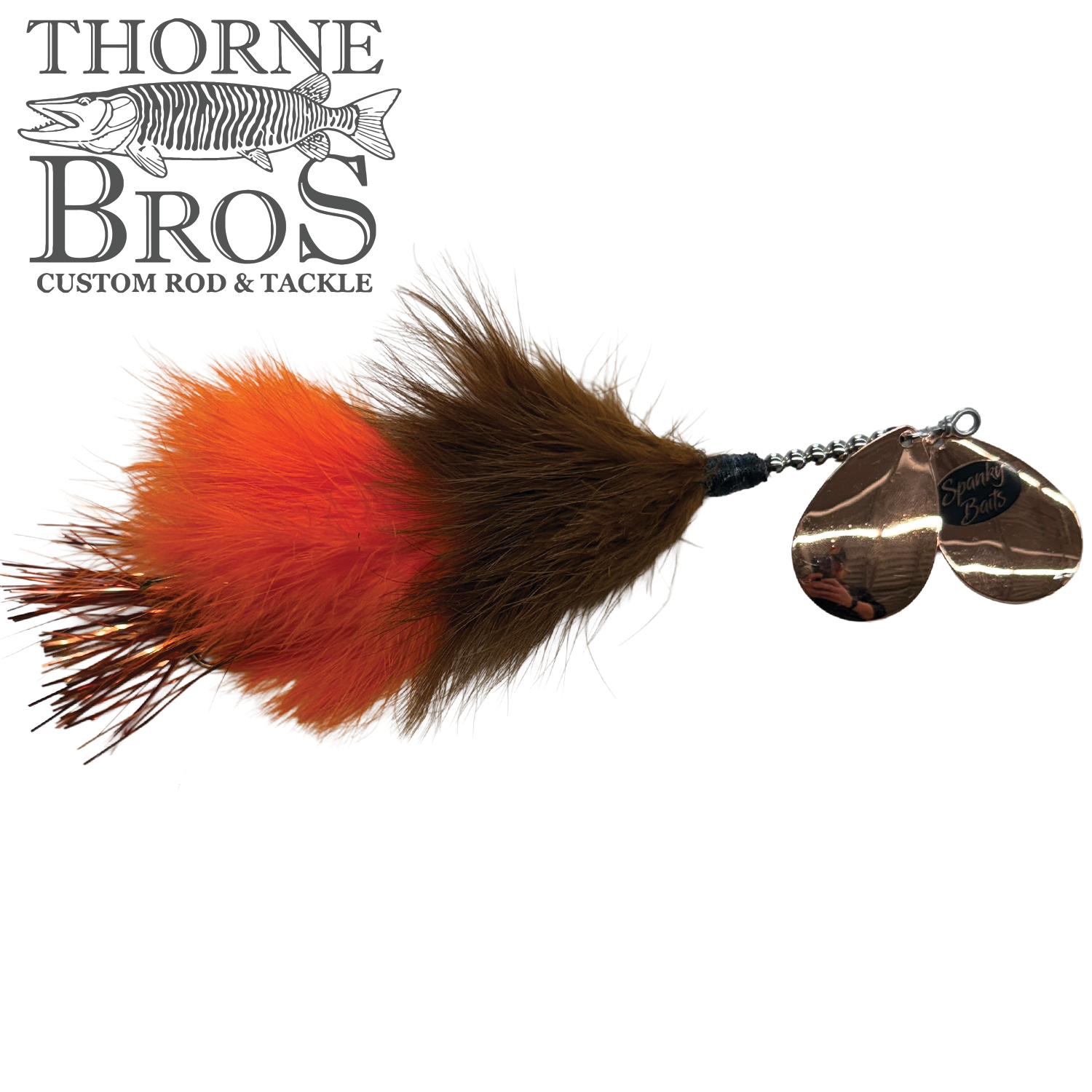 Fishing lure Spanky Baits Raven featuring bright orange and brown feather tail with shiny copper-colored double spinner blades, designed for musky fishing.