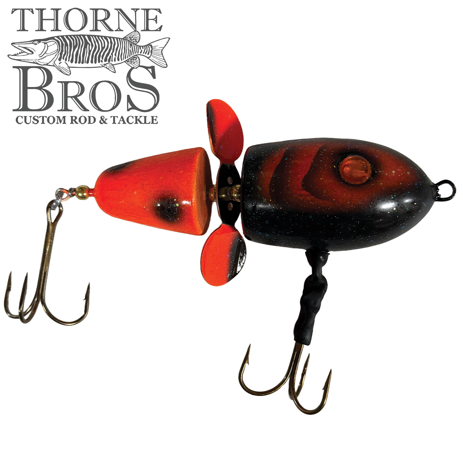 Thorne Bros Lake-X Hammer fishing lure in black and red with dual treble hooks and a propeller, designed for musky fishing tackle and custom rod setups.