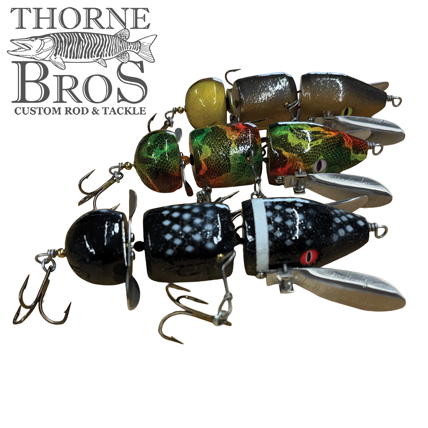 Musky Safari Franken Spitz Jr. musky fishing lure shown in multiple painted color patterns with treble hooks and metal propeller blades for topwater fishing