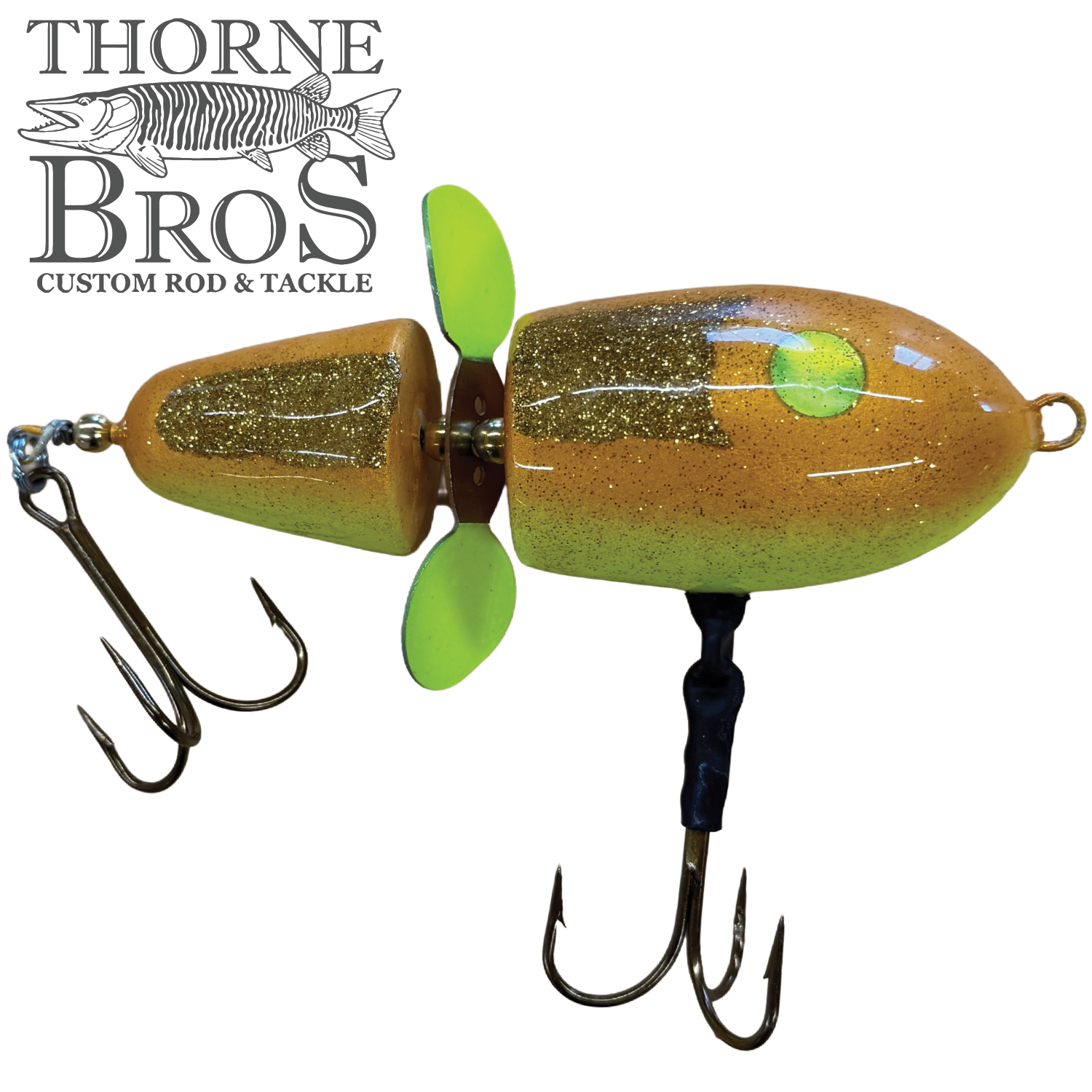 Lake-X Hammer fishing lure in tan and green with two treble hooks and a yellow-green propeller, designed for musky fishing by Thorne Bros.