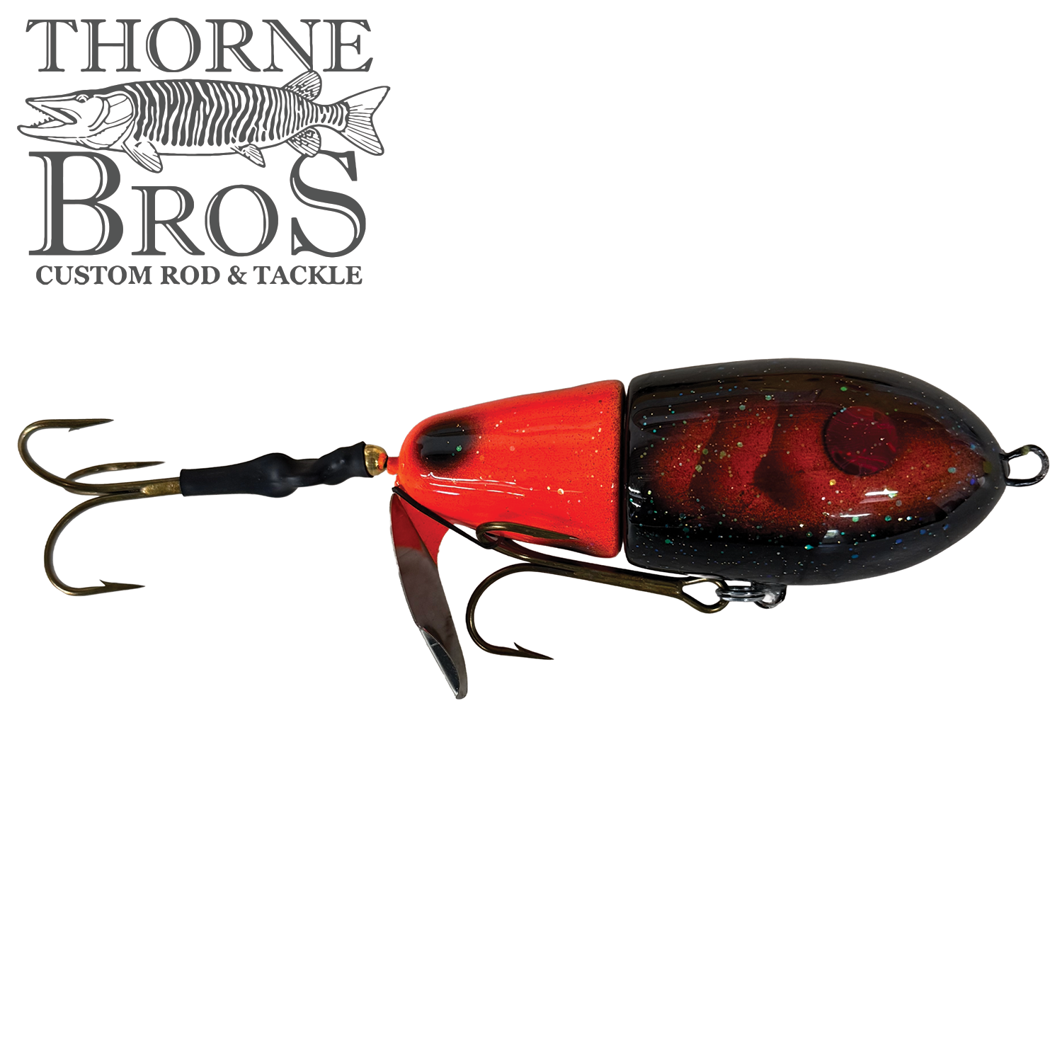 Lake-X Fat Bastard fishing lure in red and black with two sharp treble hooks, designed for musky fishing and detailed with a glossy finish and metal spinner blade.