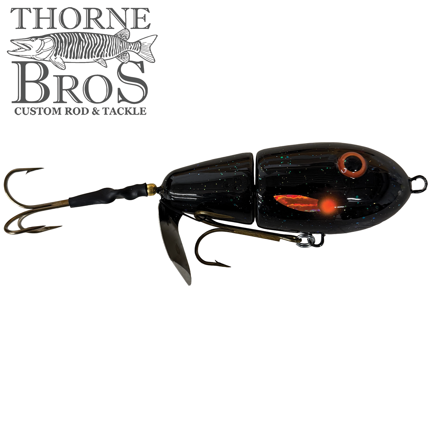 Lake-X Fat Bastard fishing lure with a jointed black body featuring subtle glitter, realistic eye detail, and multiple sharp treble hooks designed for musky fishing.