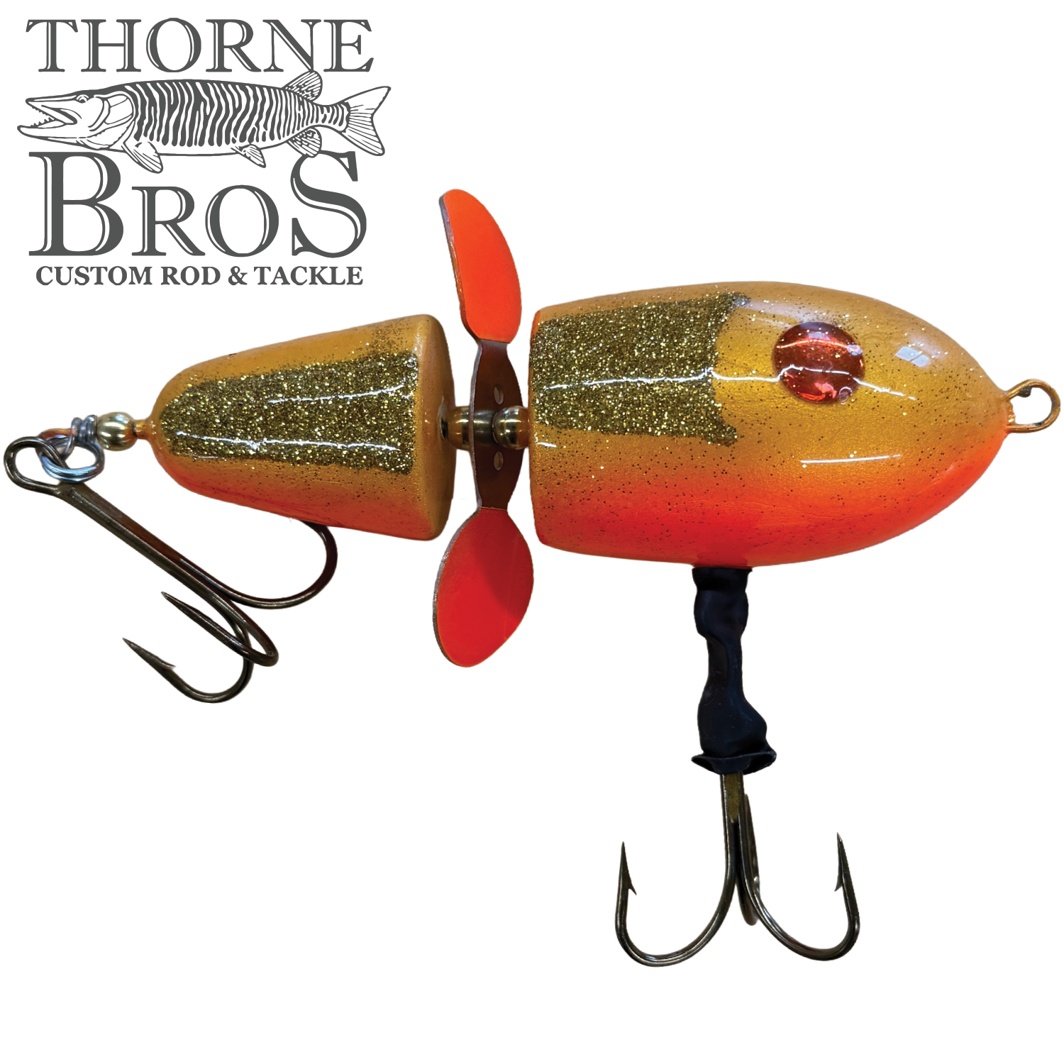 Lake-X Hammer fishing lure with vibrant orange and gold glitter finish, two treble hooks, and a red propeller designed for musky fishing.