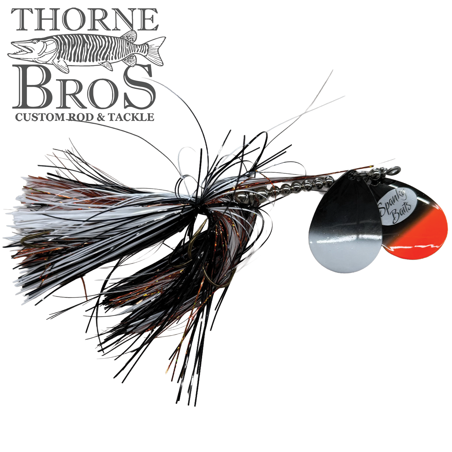 Spanky Baits Fireball 8" fishing lure featuring black, white, and orange skirt with dual silver and orange spinner blades, designed for musky fishing tackle.
