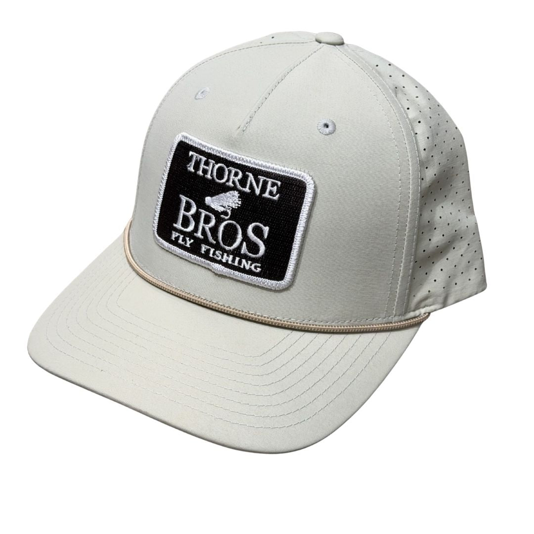 Thorne Bros Fly Fishing Logo Richardson 355 beige cap with black and white embroidered patch, perforated breathable back panels, and curved brim for outdoor fishing use.