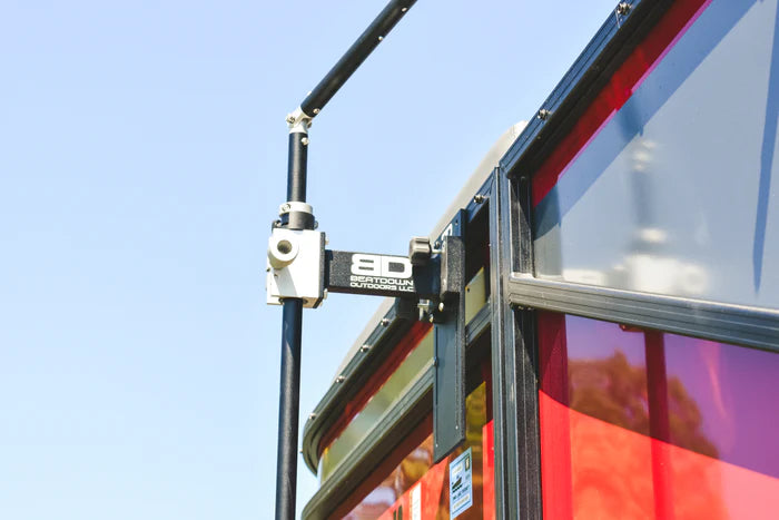 Beatdown Outdoors Pontoon - Fixed Transducer Pole SKU:TPOLE-FIXED-AT-PONTOON mounted on the side of a red pontoon boat against a clear blue sky, designed for secure marine electronics installation.
