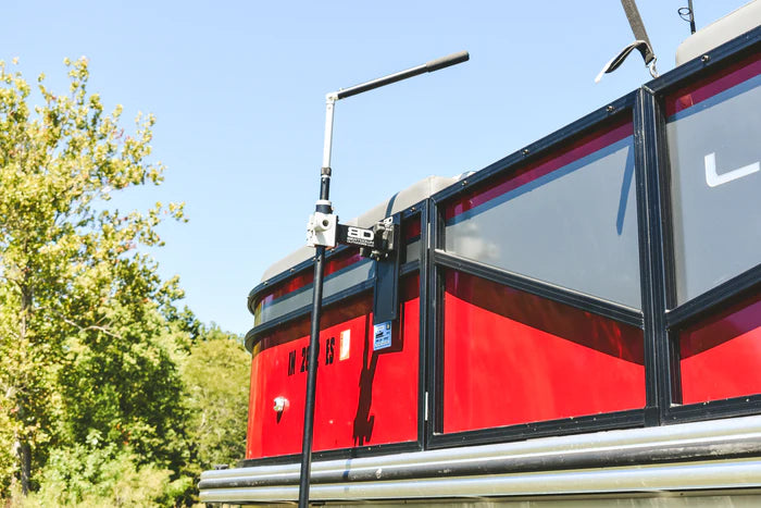 Beatdown Outdoors Pontoon - Fixed Transducer Pole SKU:TPOLE-FIXED-AT-PONTOON mounted on a red pontoon boat with a clear sky and trees in the background, used for fishing tackle and marine electronics.