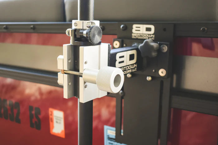 Close-up of a black and silver mounting bracket attached to a pontoon railing, showing detailed adjustment knobs and hardware of the Beatdown Outdoors Pontoon - Fixed Transducer Pole SKU:TPOLE-FIXED-AT-PONTOON designed for fishing tackle and marine electronics.