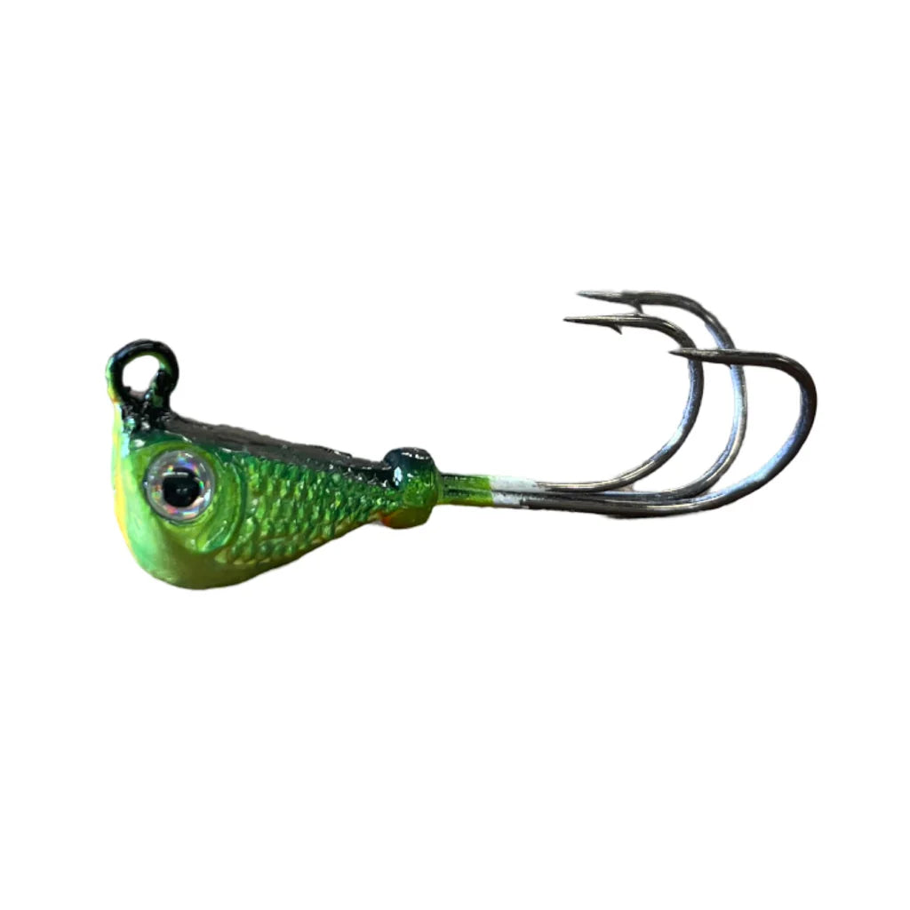 Close-up of a green and yellow Mission Tackle Grabber Jig fishing lure with a textured fish-head design and three sharp metal hooks, ideal for fishing tackle use.