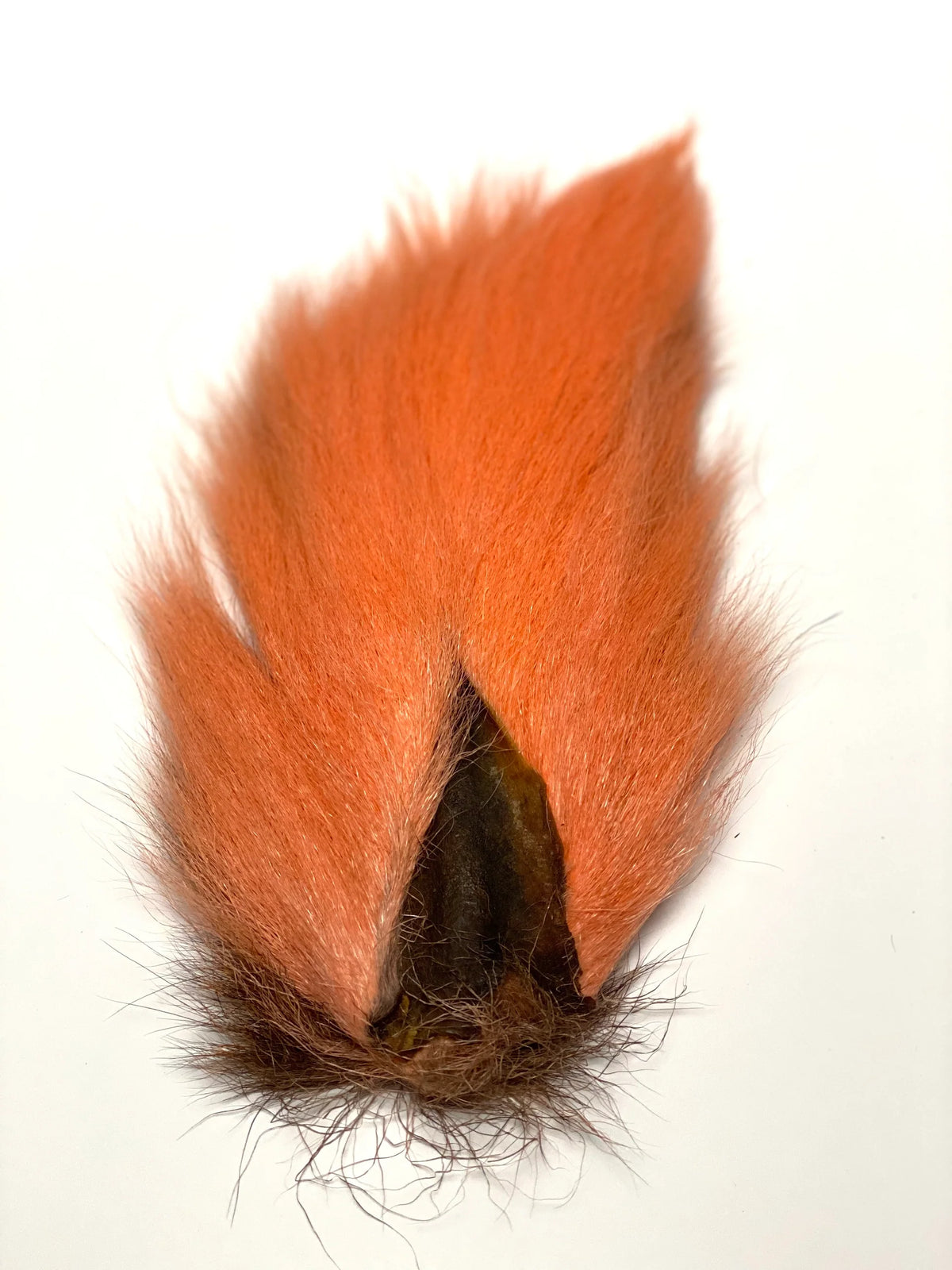 Marabou Brothers El Presidente Grade Buck Tail featuring orange and brown fur with a dark center and flowing fibers for musky fishing tackle