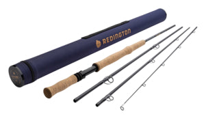 Redington Big Game Fly Rods displayed disassembled with cork handles, graphite rod sections, and a protective blue carrying tube featuring the Redington logo, ideal for fishing tackle enthusiasts.