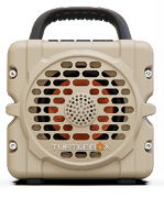 Turtlebox Cub compact tan portable speaker with rugged protective casing carry handle and front grille for outdoor adventures