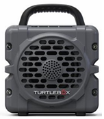 Turtlebox Cub rugged portable speaker in dark gray with a protective grille and built in carry handle for outdoor listening