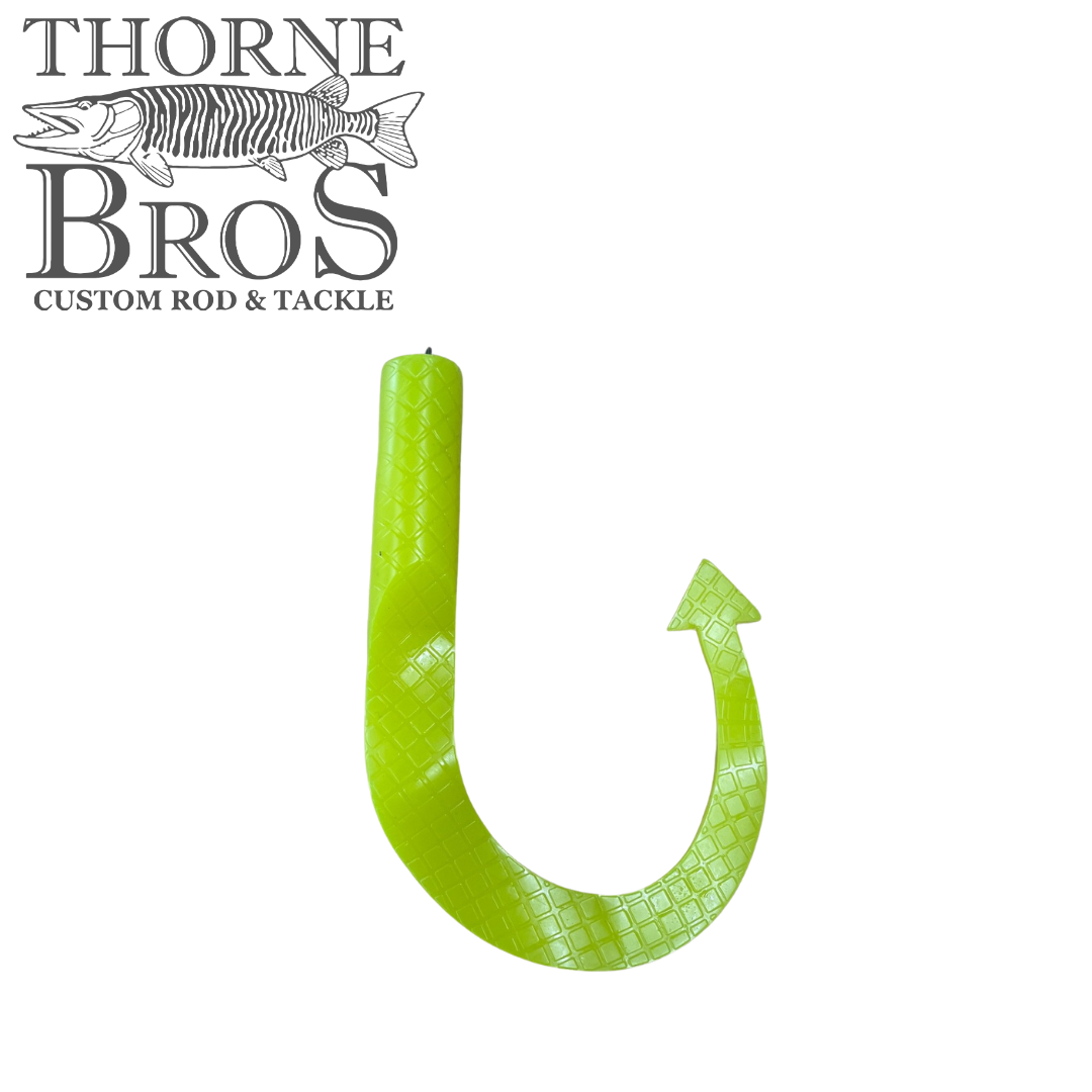 Bright green Boss Shad Hybrid Tails fishing lure with textured surface and curved hook-like tail, designed for effective fishing tackle use.
