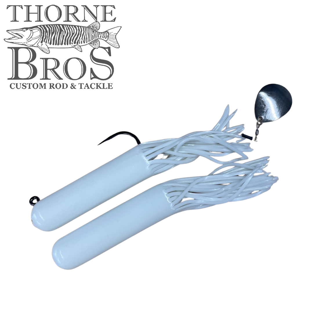 Drop Tine Chunker Tubes fishing lure in white with soft, flexible skirt strands, sharp hook, and attached silver spinner blade, designed for musky fishing tackle use.