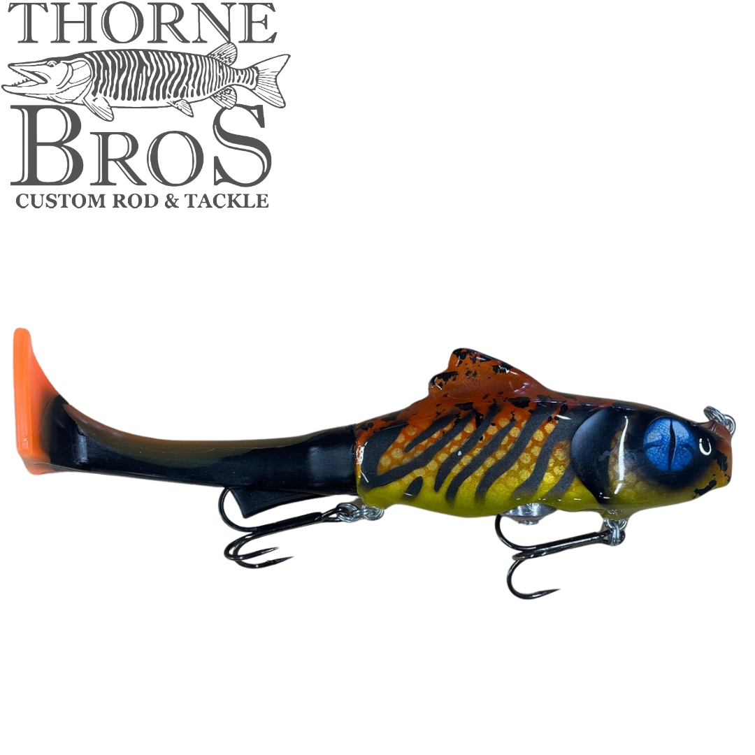 Zilla Baits Junior Hooker fishing lure with a striped, multicolored body and orange tail, featuring two treble hooks designed for freshwater fishing tackle.