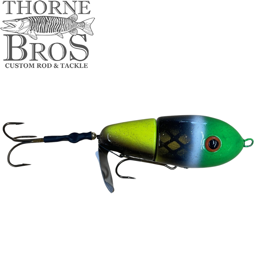 Lake-X Fat Bastard (Epoxy Finish) fishing lure in green, yellow, black, and blue tones with treble hooks and a metal lip, designed for musky fishing.