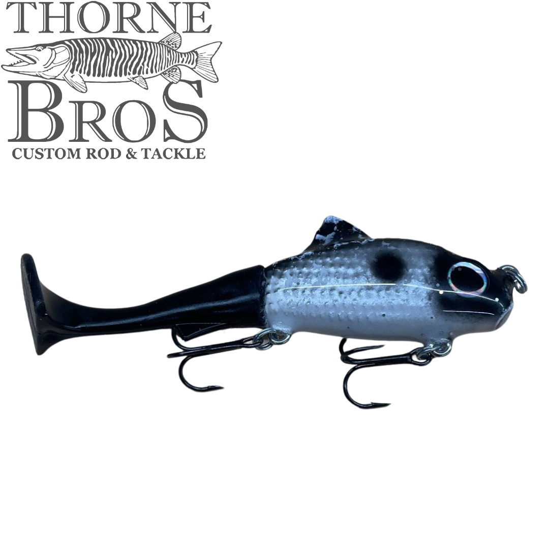 Zilla Baits TicTak black and gray fish shaped fishing lure with molded details and treble hooks displayed on a white background