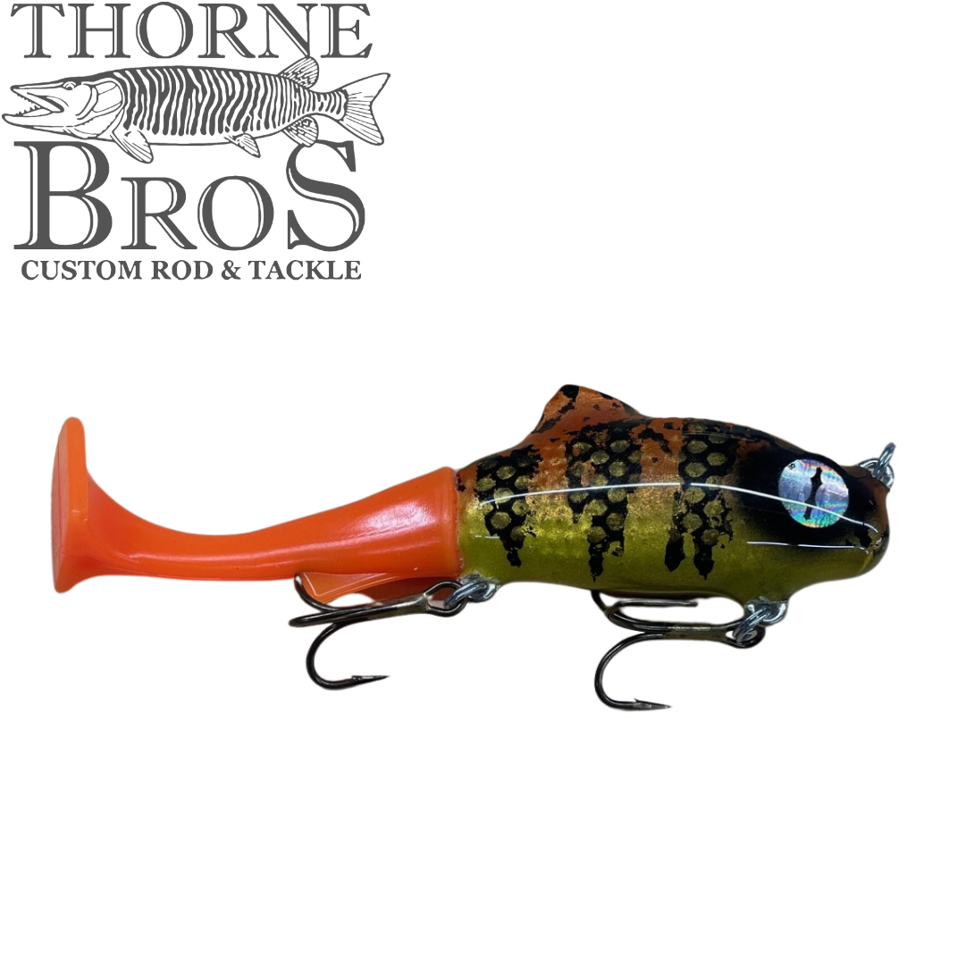Zilla Baits TicTak musky fishing lure with an orange soft plastic tail mottled green and black body and treble hooks for targeting muskies