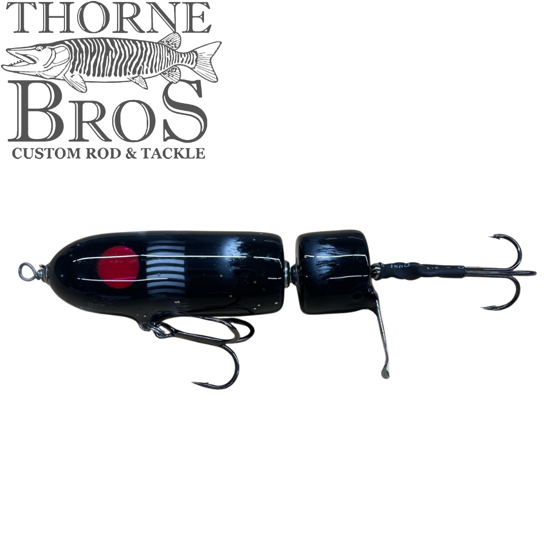 Zilla Baits PropWash black topwater musky fishing lure with propeller tail and treble hooks shown on a white background