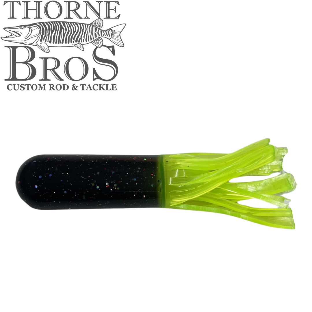 Red October Replacement Tubes - 7.5" (Tube Rig Sold Separately) shown as a black and chartreuse soft fishing lure with glitter flecks and a fluttering tail