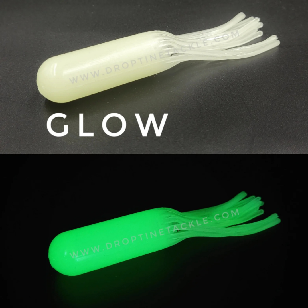 Drop Tine 4" Trout Tube - Fatty" fishing lure shown in natural light with a soft white color and glowing bright green in the dark, designed for attracting fish.