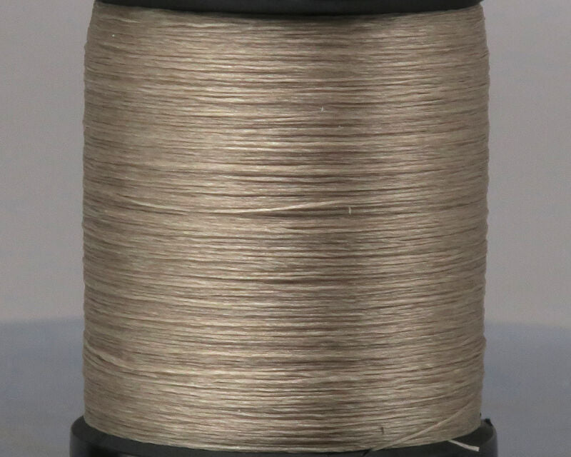 Close-up of a spool of beige UNI 8/0 Thread used in fishing tackle and custom rod building for precise, durable wraps on rods and reels.