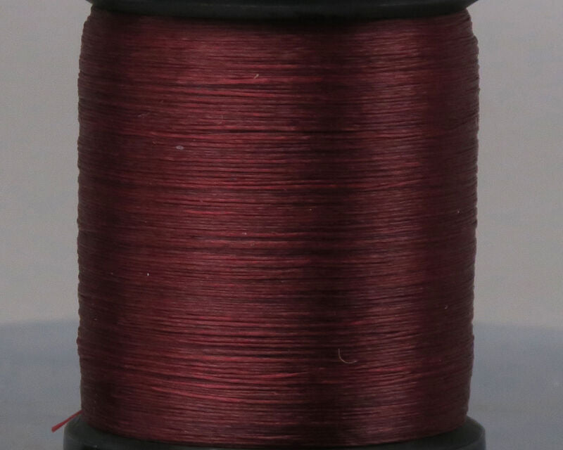 Close-up view of a spool of deep red thread labeled UNI 8/0 Thread, used for tying custom fishing rods and fishing tackle.