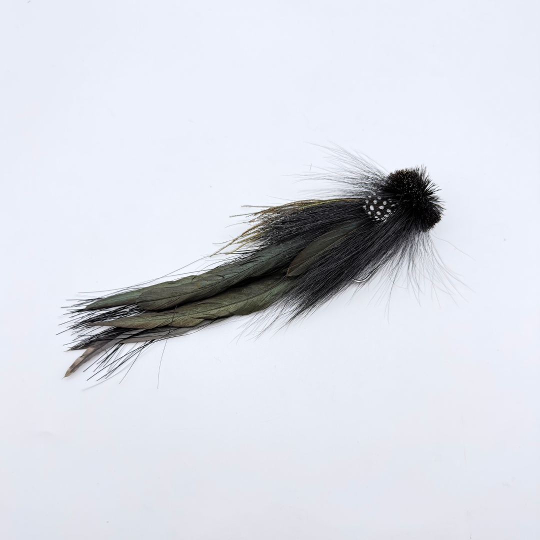 Single Buford Urban Fly Co. fishing lure with detailed black and dark green feathers designed for fly fishing, ideal for attracting musky and other large fish.