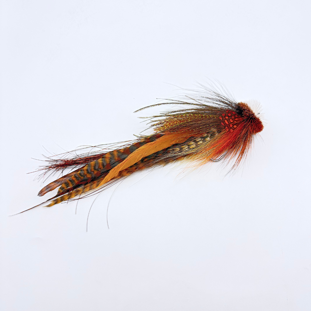 Single Buford Urban Fly Co. fishing lure featuring detailed feathers in brown, orange, and black tones designed for fly fishing and musky tackle.