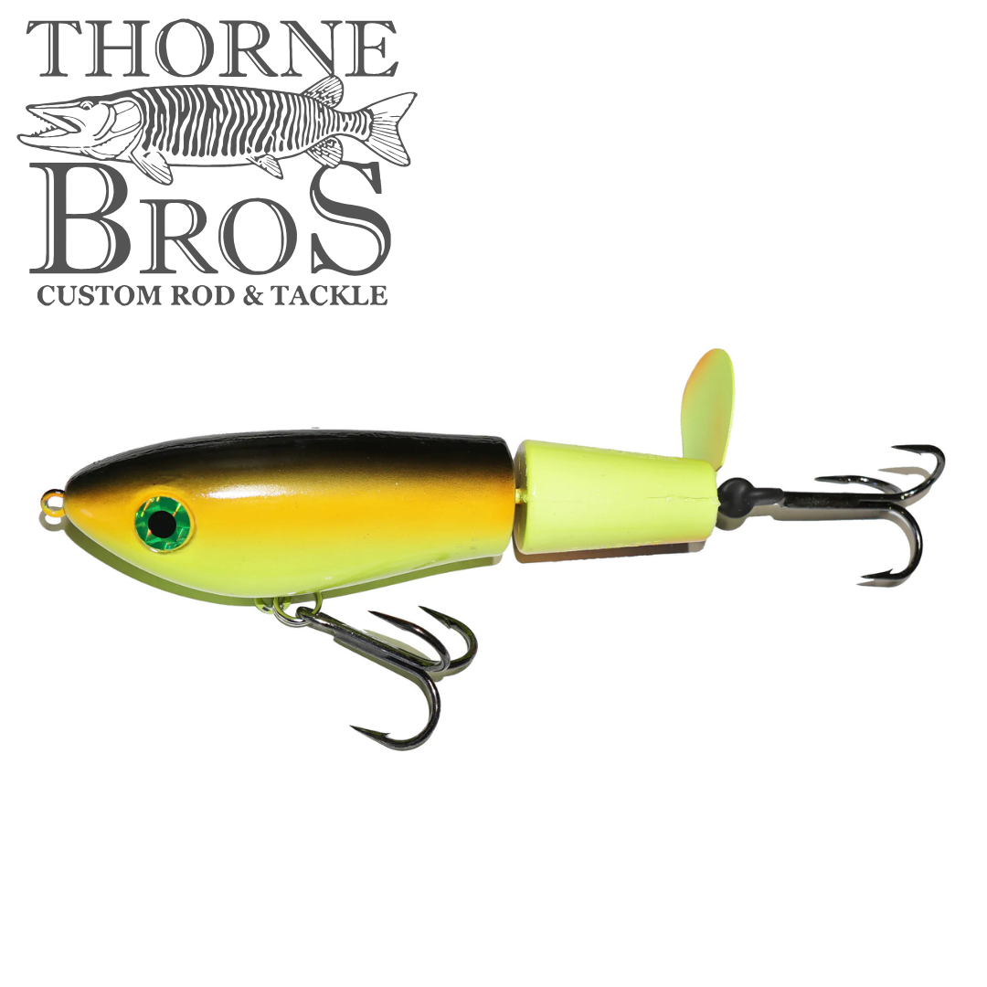 Bucher Topraider fishing lure in yellow and black with dual treble hooks and a small rear propeller, designed for musky fishing by Thorne Bros.