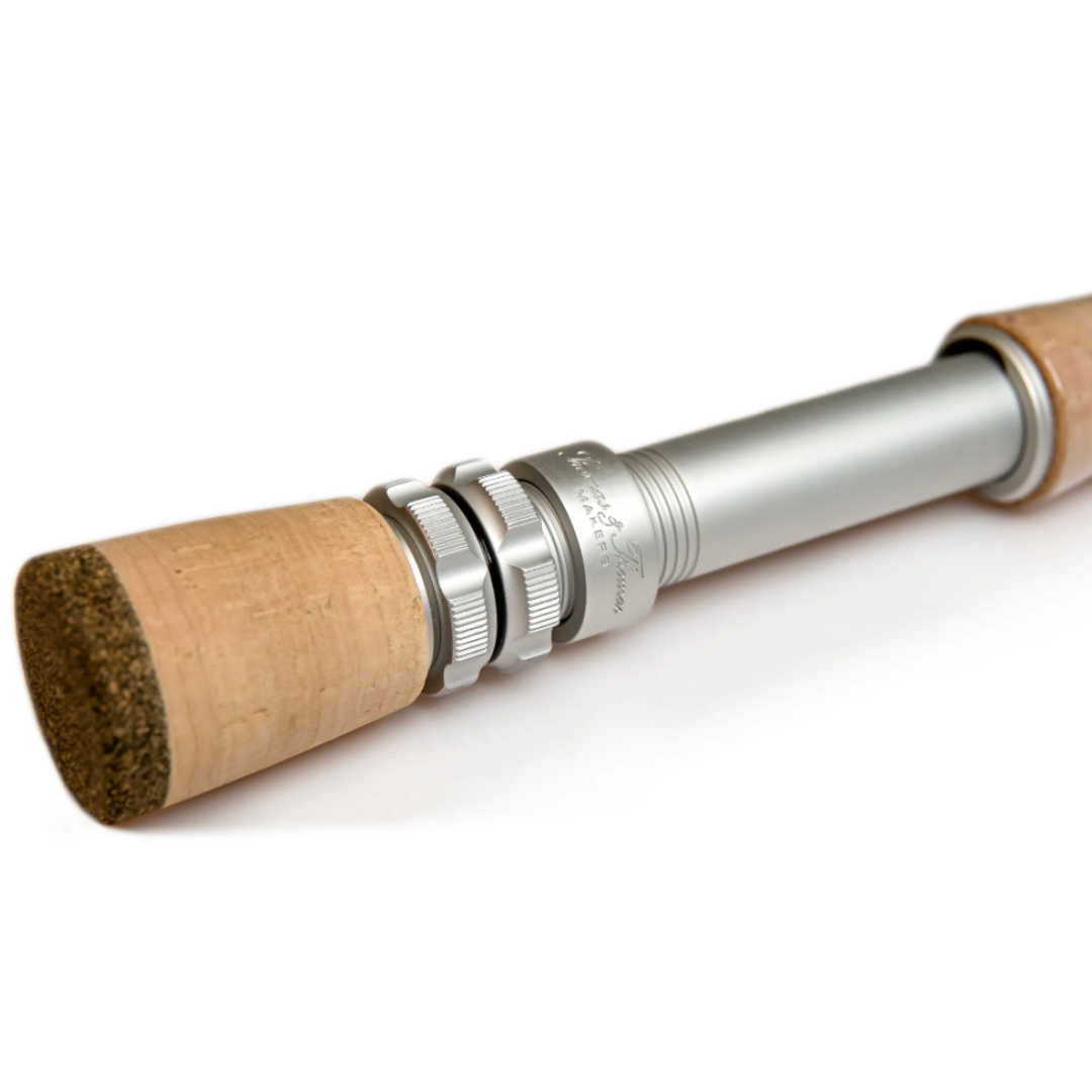 Close-up image of the handle and reel seat of the Thomas & Thomas Sextant Fly Rod, featuring a cork grip and silver metal adjustable reel seat designed for precision fishing tackle use.