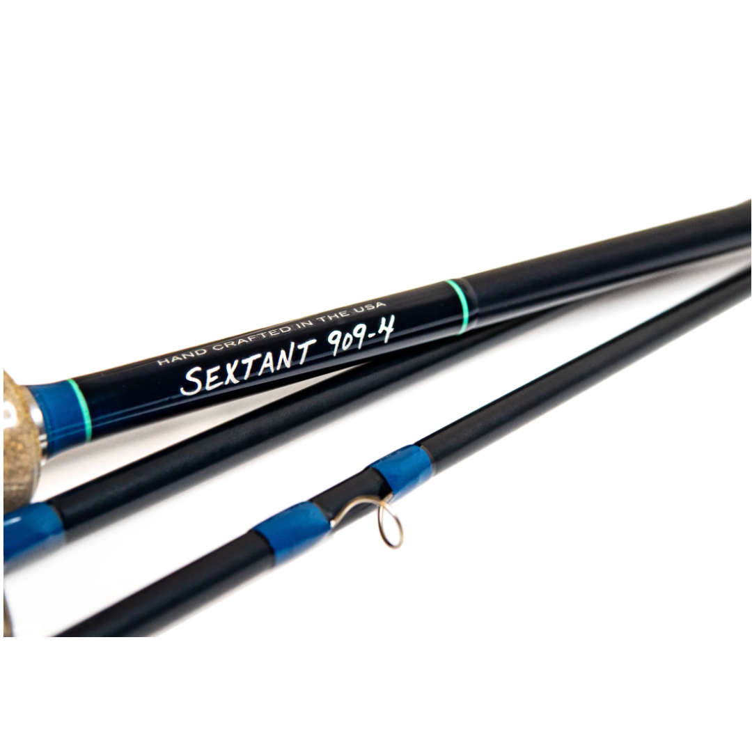Close-up of a Thomas & Thomas Sextant Fly Rod showcasing its black finish, blue accents, and handcrafted details on the blank and guide wraps, designed for fishing enthusiasts.
