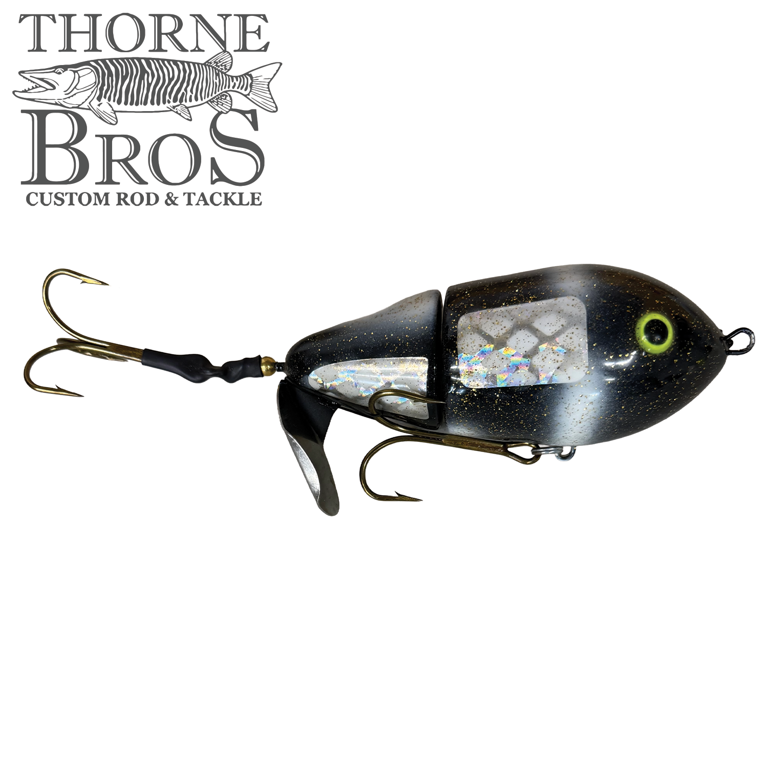 Lake-X Cannonball JR. fishing lure in black with reflective scale pattern, two sharp treble hooks, and a small metal spinning blade for musky fishing tackle.