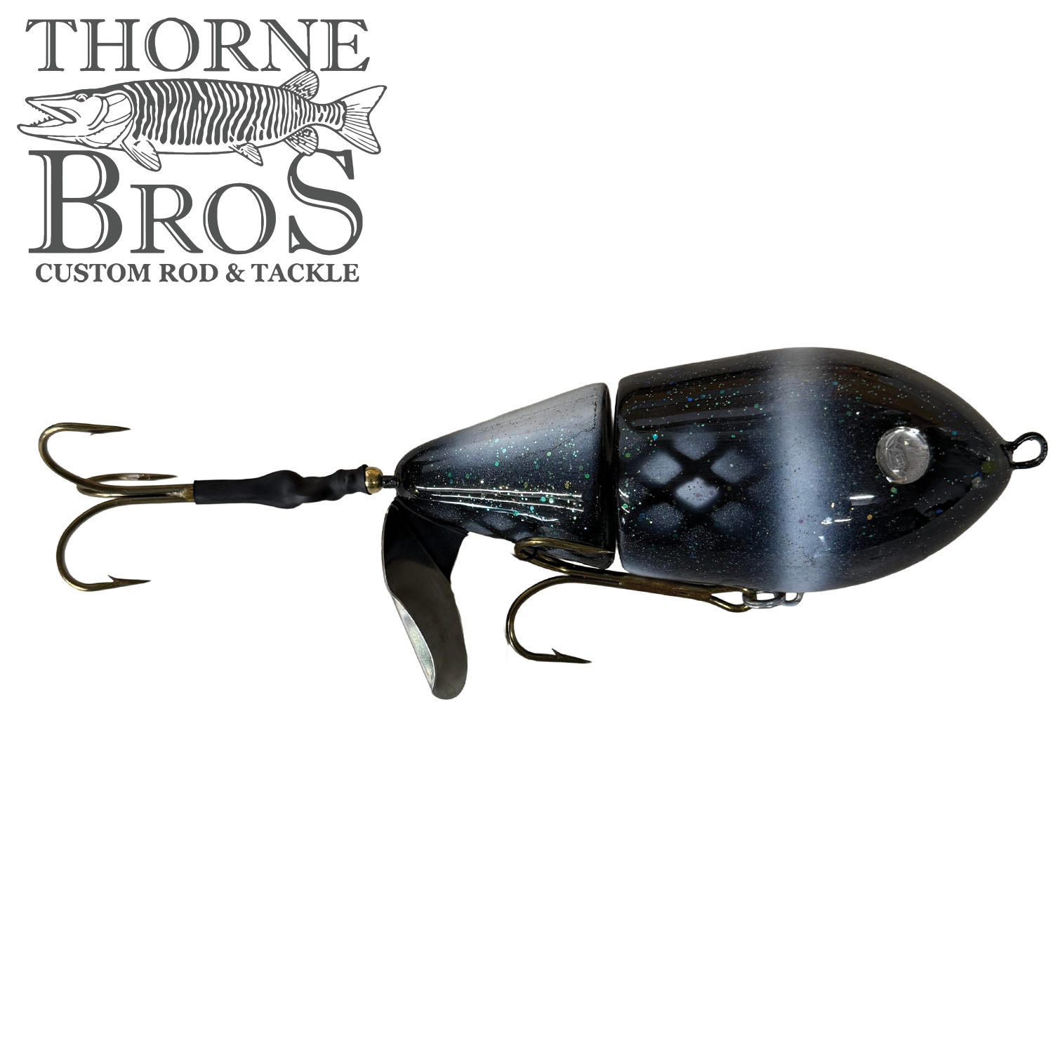 Lake-X Cannonball JR. fishing lure with jointed black and silver body, reflective scale pattern, two treble hooks, and a small metal spinner blade for musky fishing.