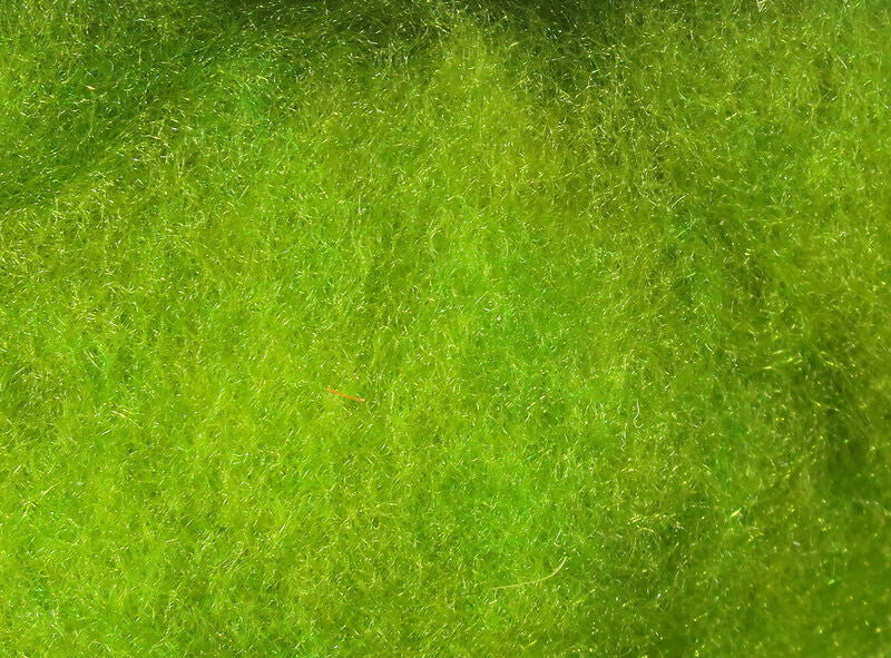 Close-up view of bright green synthetic fibers from the Hareline Super Fine Dry Fly used in fishing tackle for creating detailed, effective dry flies.