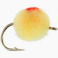 Close-up of an Egg Fly fishing lure with a soft, round, pale yellow body featuring a small red spot on top, designed for musky and fly fishing tackle.