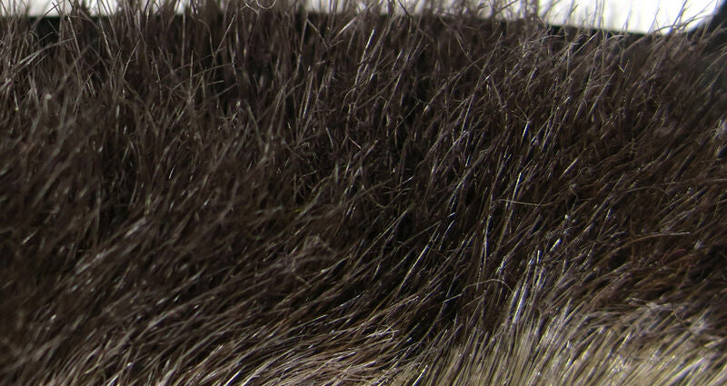 Close-up view of natural brown and gray fur texture on Hareline Snowshoe Rabbit Feet, used for creating fishing tackle and lures.