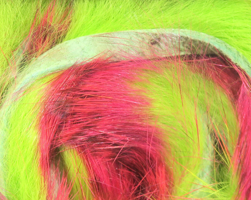 Close-up of Hareline Rabbit Strip - Tiger Bar featuring bright yellow and red strands of soft, natural rabbit fur for use as fishing tackle in musky and fly fishing.