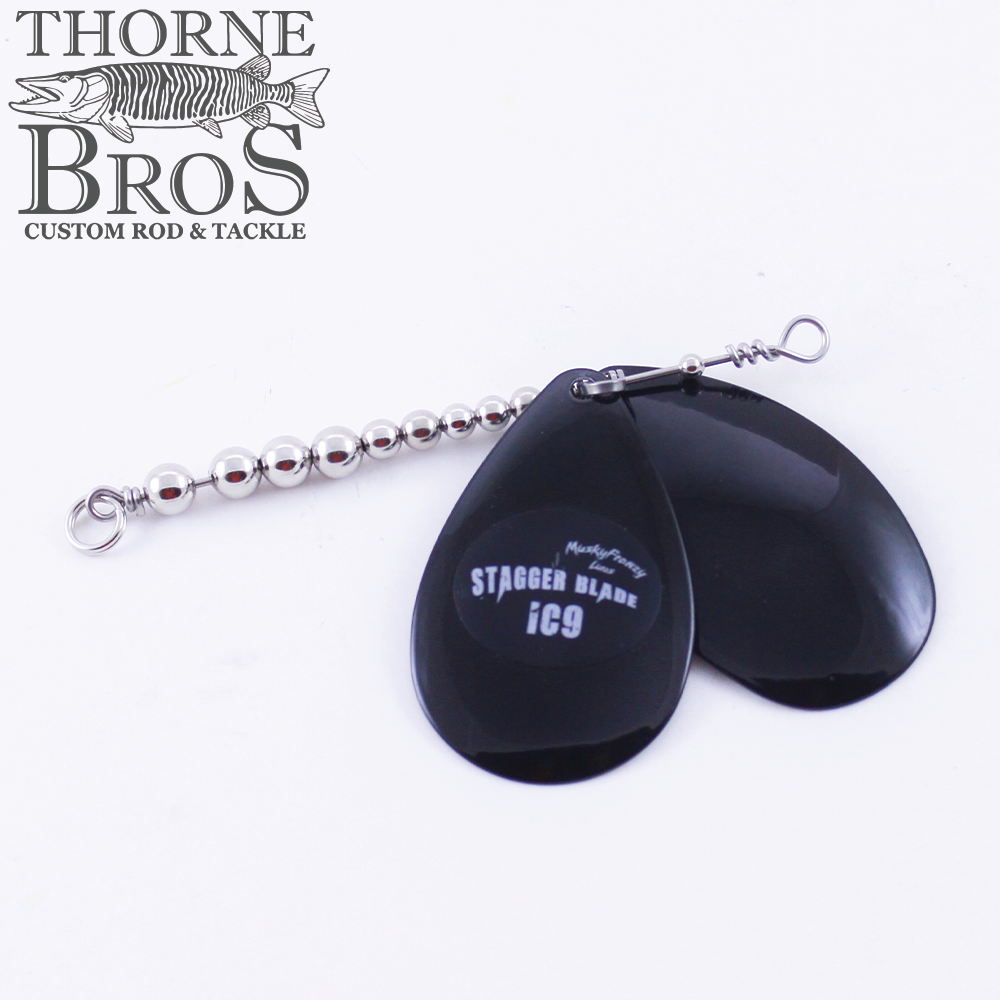 Musky Frenzy Blade Attachments featuring two black staggered blades connected to a beaded metal wire, designed for fishing tackle to enhance lure movement and attract fish.