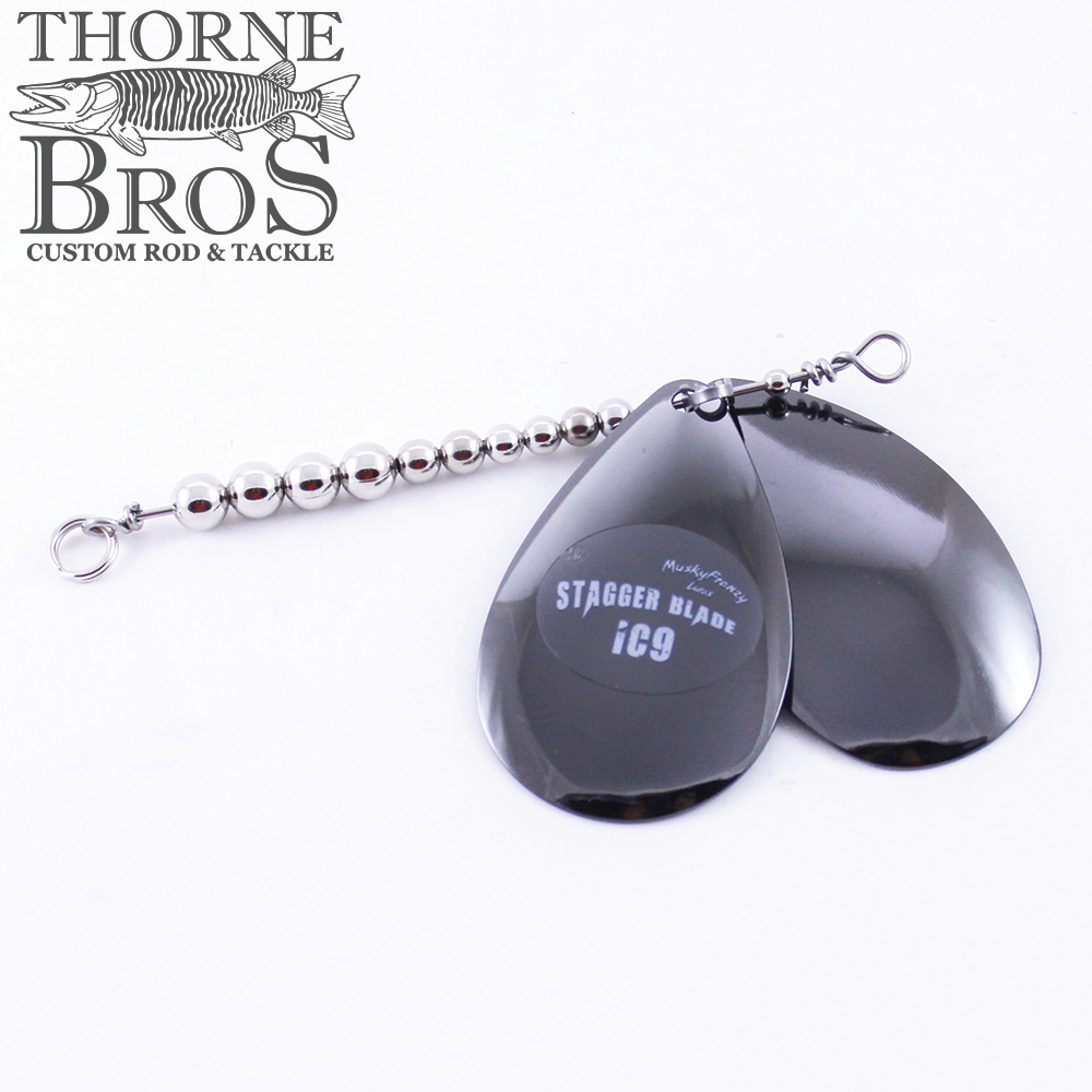 Close-up of shiny metal Musky Frenzy Blade Attachments with two large black teardrop-shaped spinner blades and a beaded silver wire shaft designed for fishing tackle use.